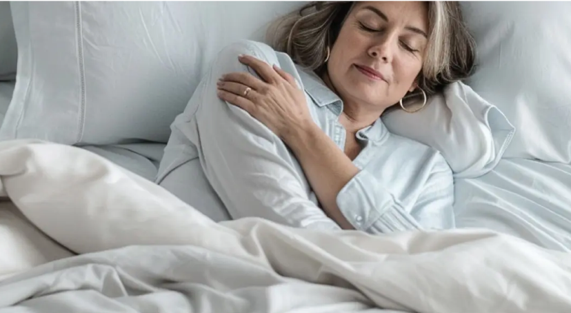 Woman sleeping in Miracle Made sheets